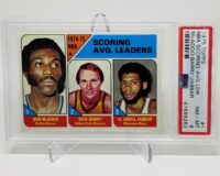 a 1975 Topps NBA Scoring Leaders McAdoo/Barry/Jabbar #1 PSA 8 card with three players on it.