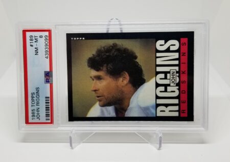a card with a picture of 1985 Topps John Riggins #189 PSA 8.