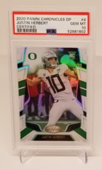 a card with a picture of 2020 Panini Chronicles DP Certified Justin Herbert #4 PSA 10.