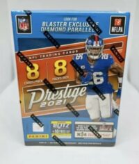 A sealed box of 2021 Panini Prestige Blaster Box trading cards featuring a football player in a blue jersey on the cover.